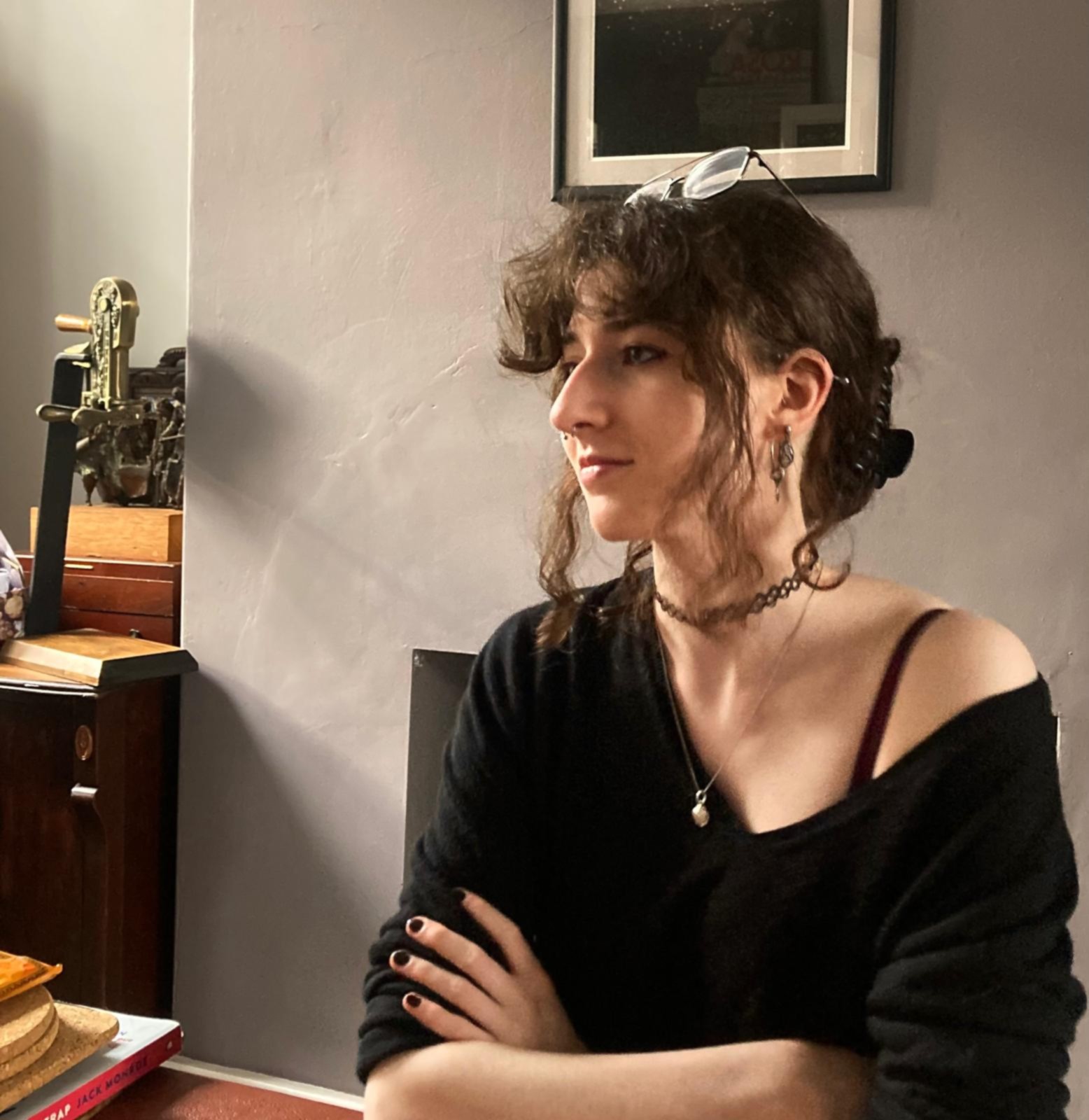 A picture of someone sitting down staring off to the left